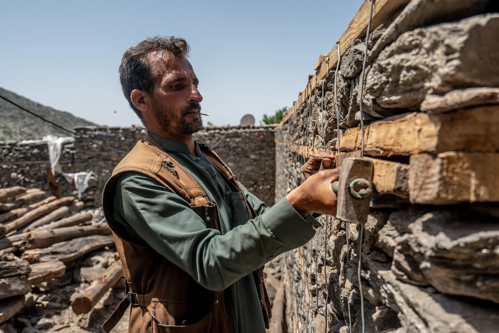 After the 2025 earthquake in eastern Afghanistan, a resident of Dar-e-Nor district, Nangarhar, builds his new home. Rebuilding with his own hands, using new earthquake-resistant building techniques he learnt through R.E.V.I.V.E. support, he is helping his family move from emergency shelter towards a more secure future.