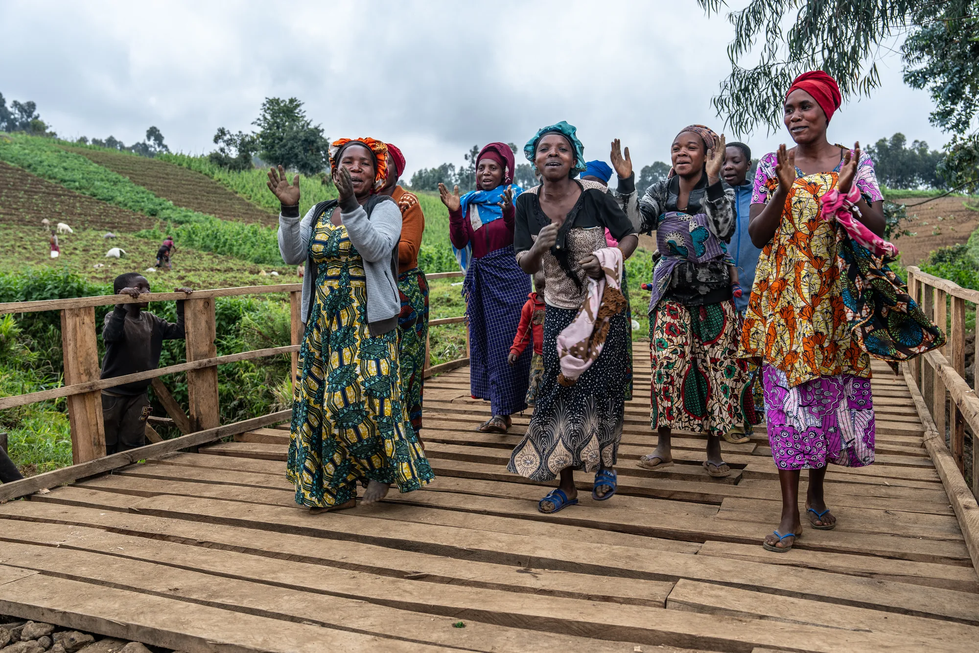 Women celebrate the opening of the Rusisiro Bridge in eastern Democratic Republic of the Congo. Rebuilt after years of conflict, the bridge makes it easier for farmers to reach their fields and markets, helping reduce crop losses, increase incomes and reconnect communities.
