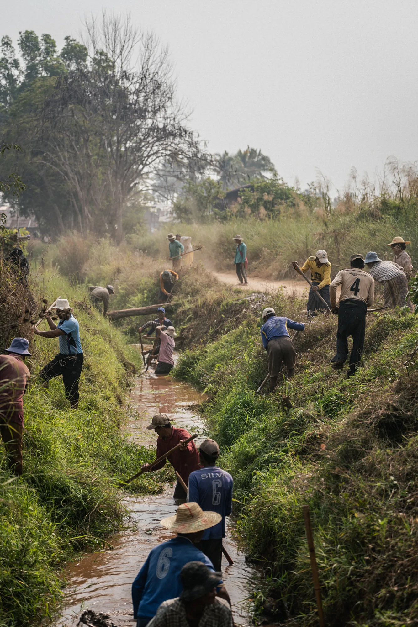 After landslides damaged farmland following the 2025 earthquake, residents repair an irrigation canal in Myanmar. Restoring the irrigation system helps farmers return to work while providing income during recovery.
