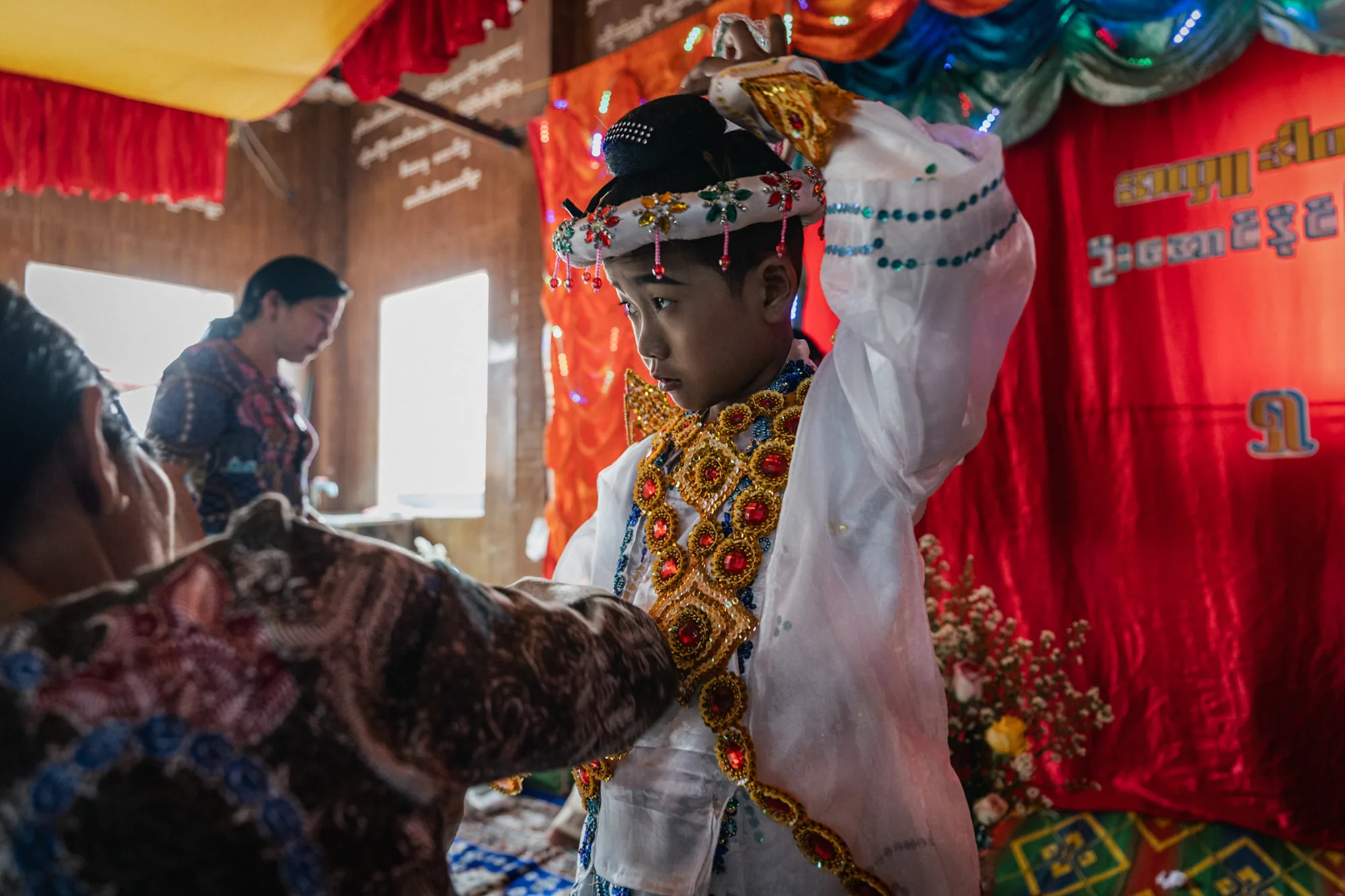 A young boy prepares for his Shinbyu ceremony in Nyaungshwe, Myanmar. Following the 2025 earthquake, the revival of this cherished ceremony brings families together and marks a gradual return to community life.
